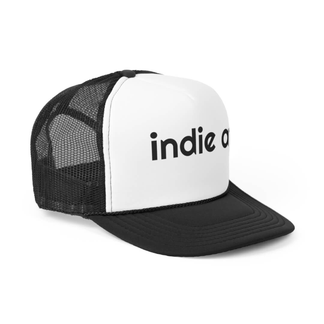The Indie AF Trucker Hat is a classic black and white cap with black mesh sides and bold “indie a” text on the front panel.