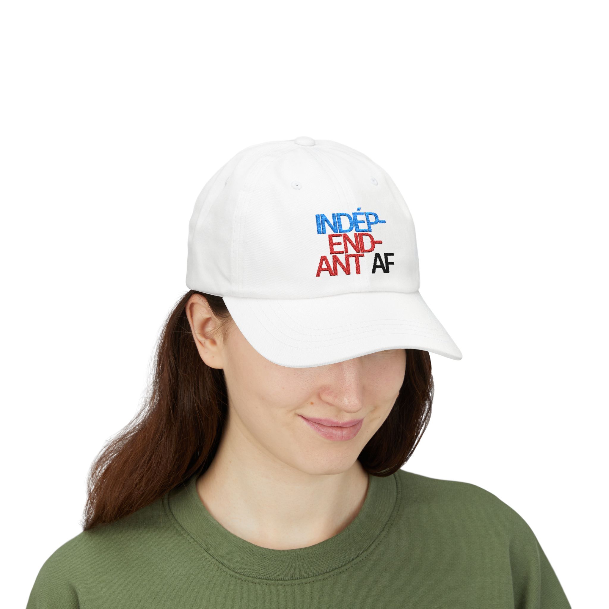 A woman wears The Macrons Secret Weakness Baseball Cap in white and a green shirt, smiling slightly as if shes keeping a secret weakness to herself.