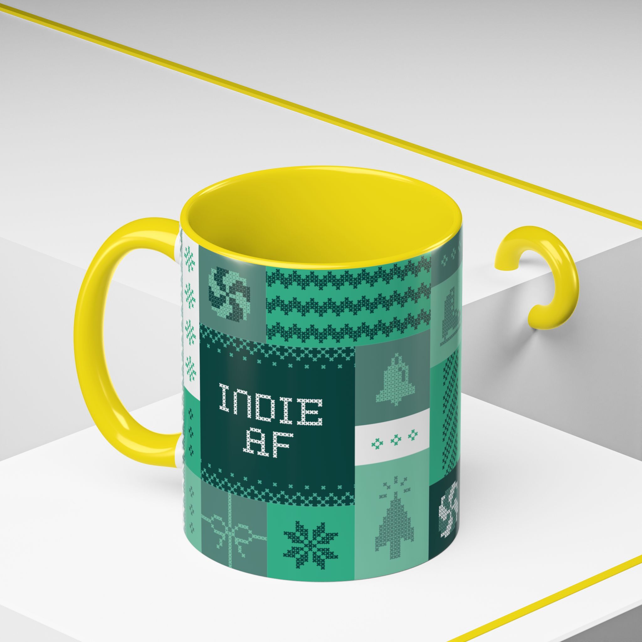 The "Mandatory Fun" Mug - Green | 11oz features a pixel art design with INDIE AF for 2025 Holidays by Grown, shown here with a loose yellow handle on a white and gray surface—perfect for indie fans.