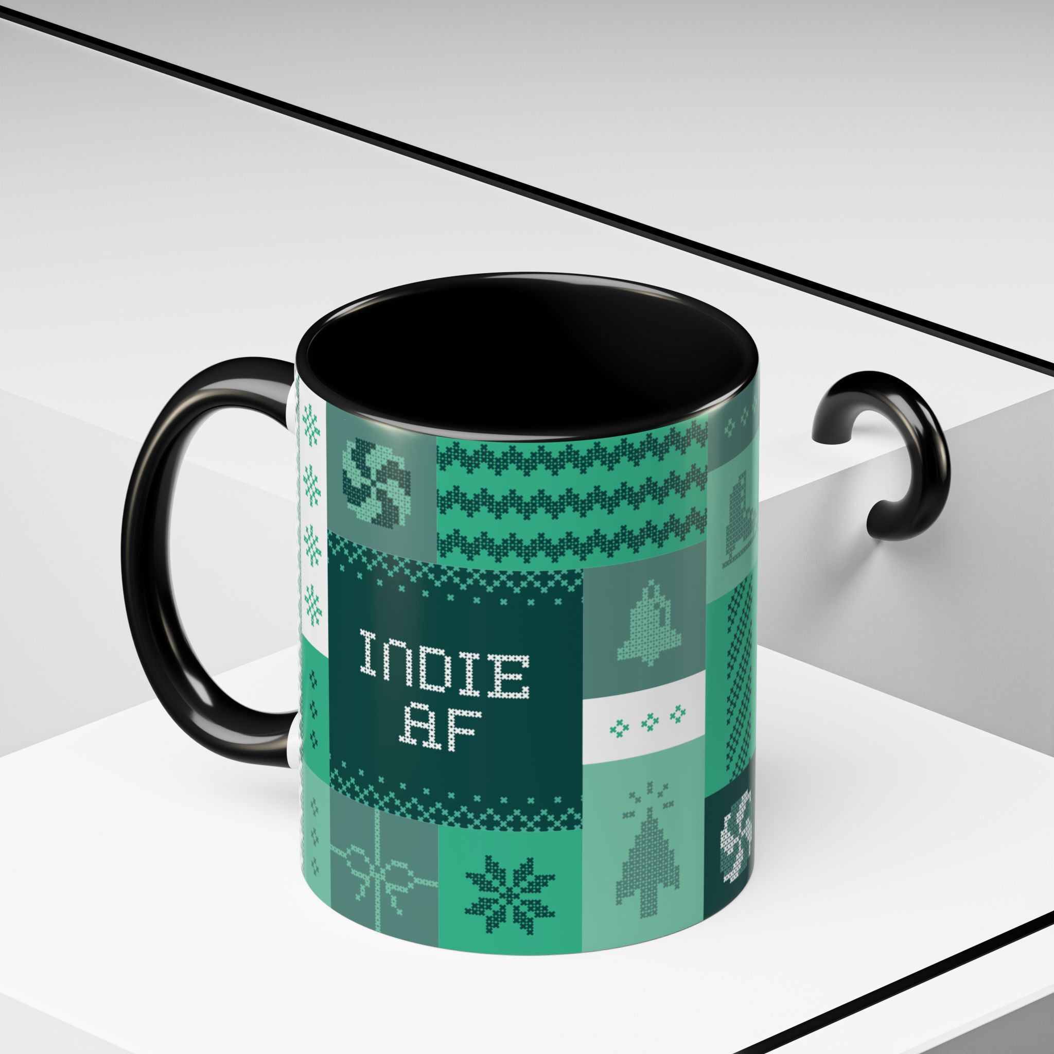 The "Mandatory Fun" Mug - Green | 11oz Indie AF 2025 Holidays by Grown features a black and green pixel art design with INDIE AF at its center, perfect for celebrating the holidays on a stylish white geometric surface.