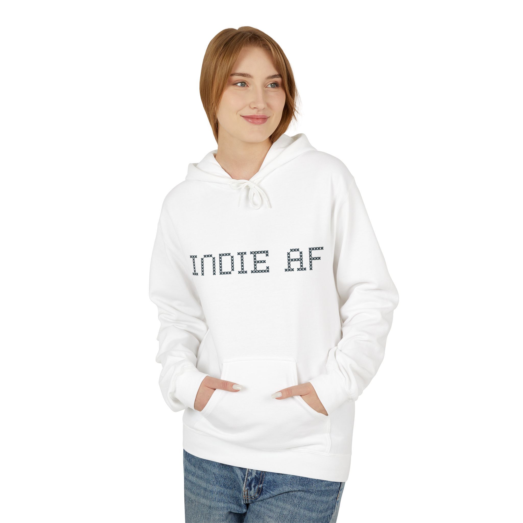 Wearing The "Uniform Rebellion" Hoodie | Indie AF 2025 Holidays by Grown with blue jeans, someone stands hands-in-pocket against a white background, serving an effortlessly grown indie vibe.