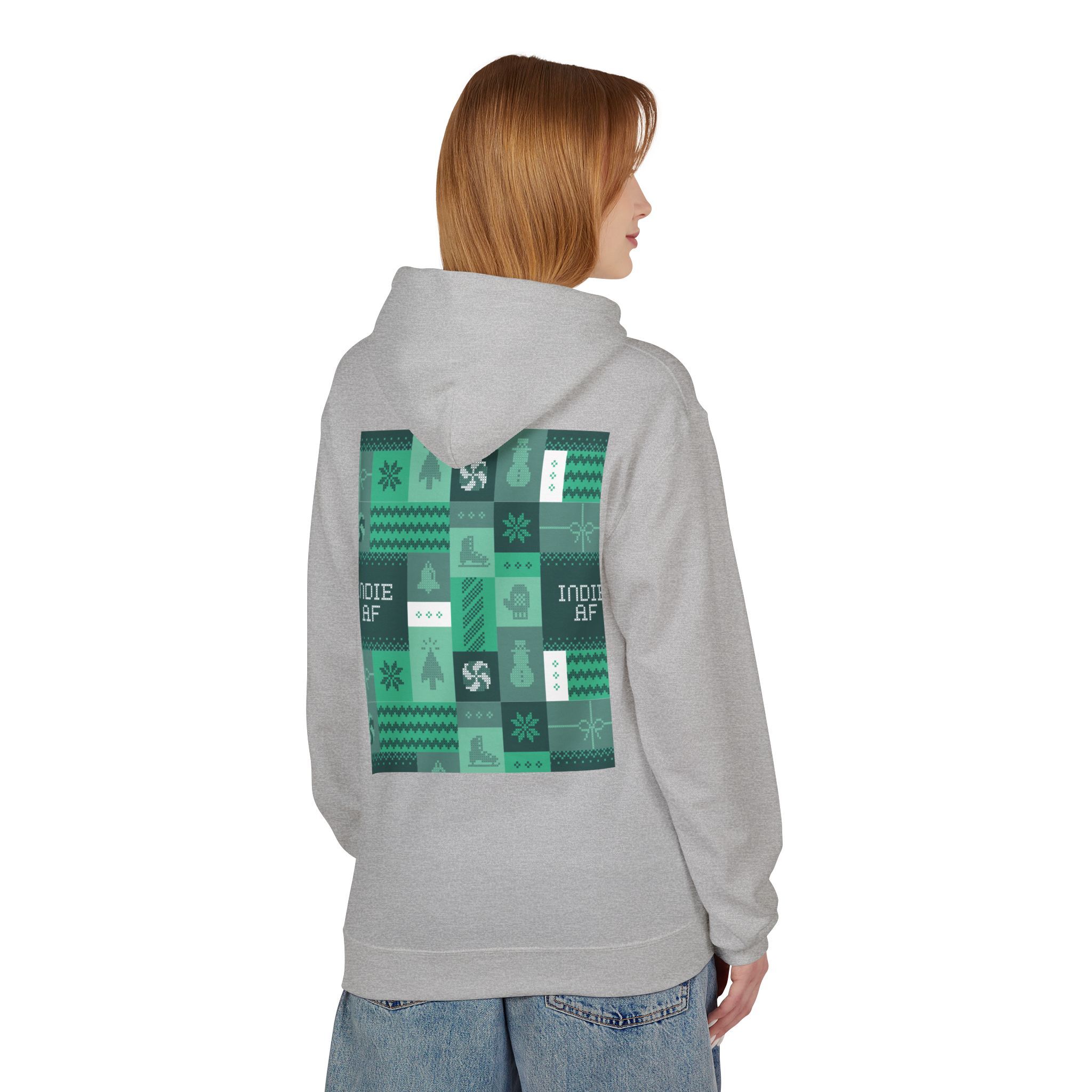 Someone stands facing away from the camera in The "Uniform Rebellion" Hoodie | Indie AF 2025 Holidays by Grown, a light gray hoodie with a green and black patterned back graphic, giving off an effortlessly indie, grown-up vibe.