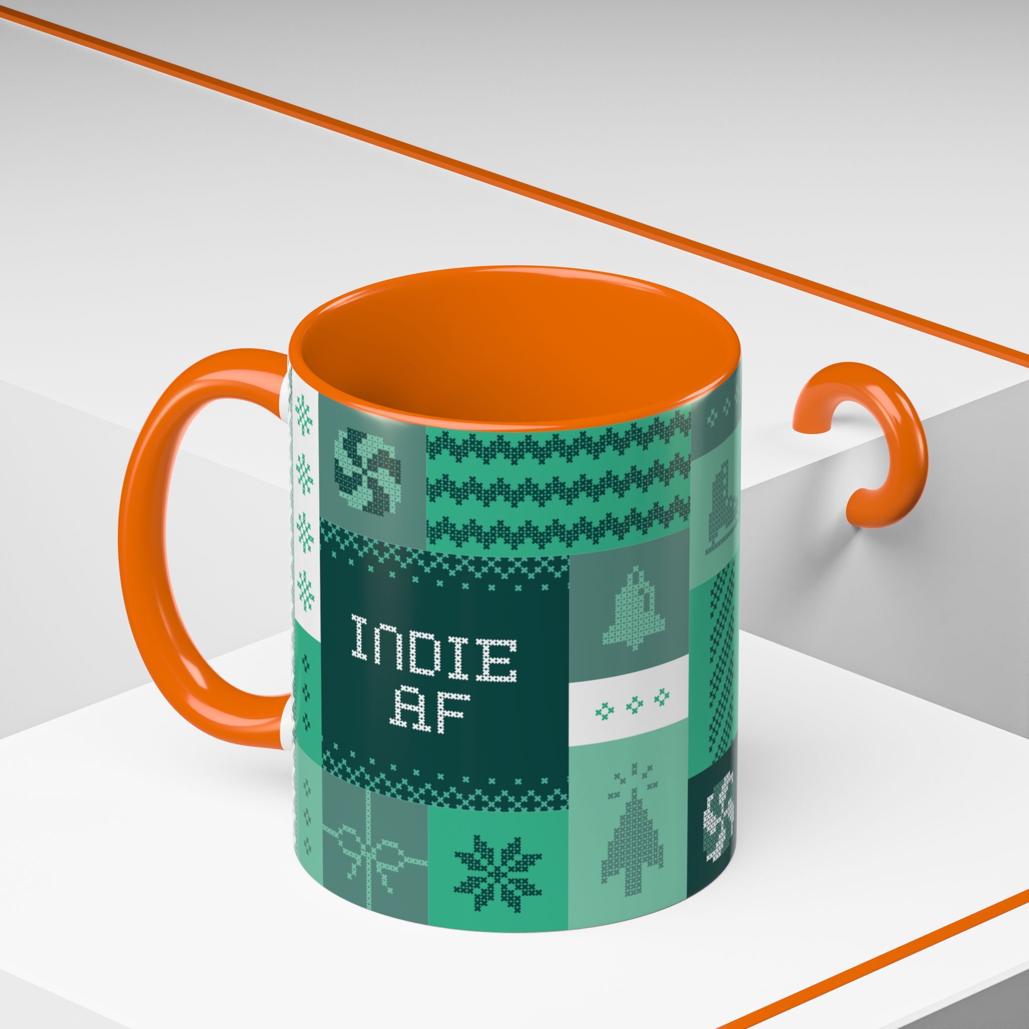 The "Mandatory Fun" Mug - Green | 11oz Indie AF 2025 Holidays by Grown features pixel art in green and orange, perfect for celebrating the 2025 holidays in style. It sits on a white surface beside an orange hook.