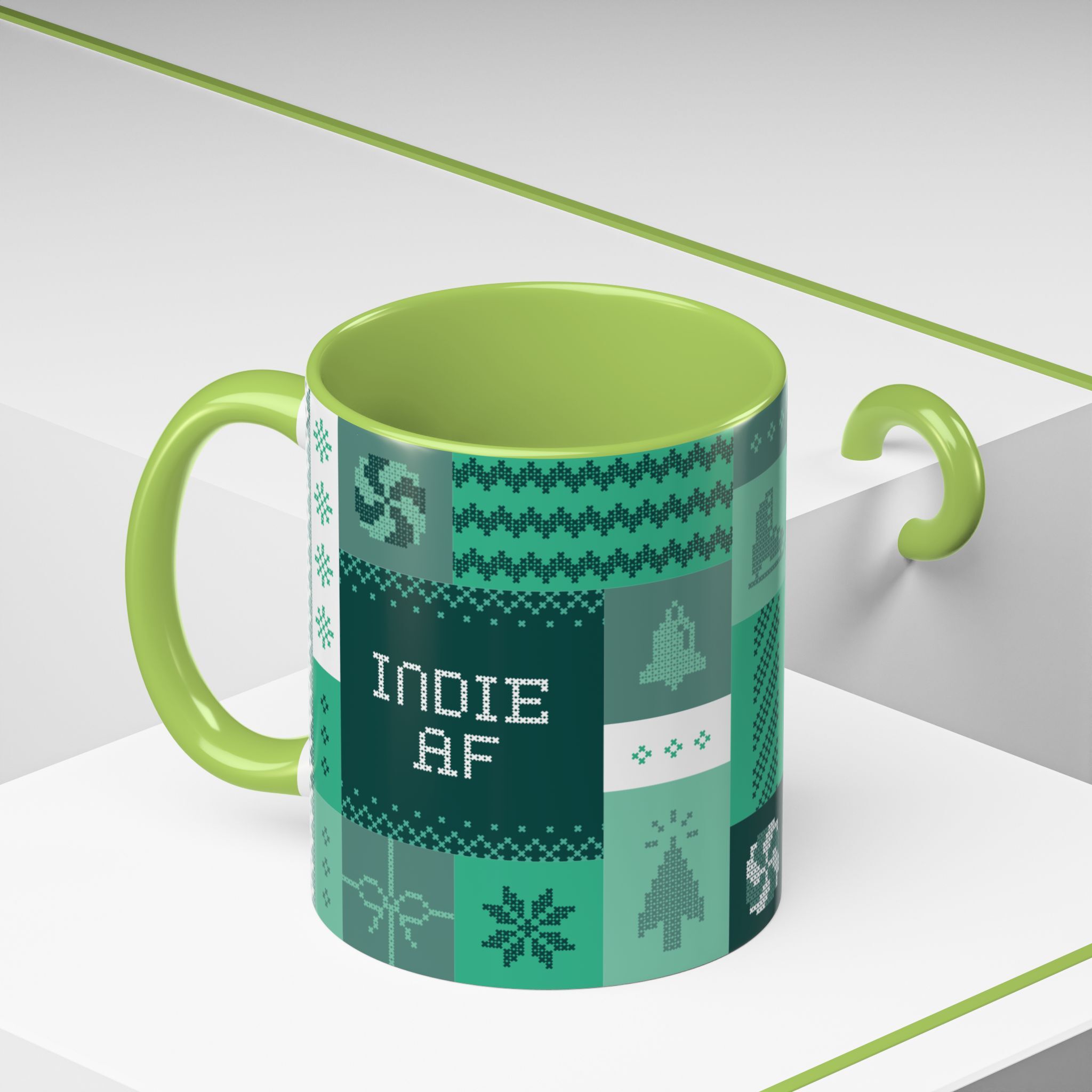 The "Mandatory Fun" Mug - Green | 11oz Indie AF 2025 Holidays by Grown features a fun patchwork pattern and INDIE AF text, making it the perfect quirky mug for the upcoming 2025 holidays. Photographed on a white geometric surface.
