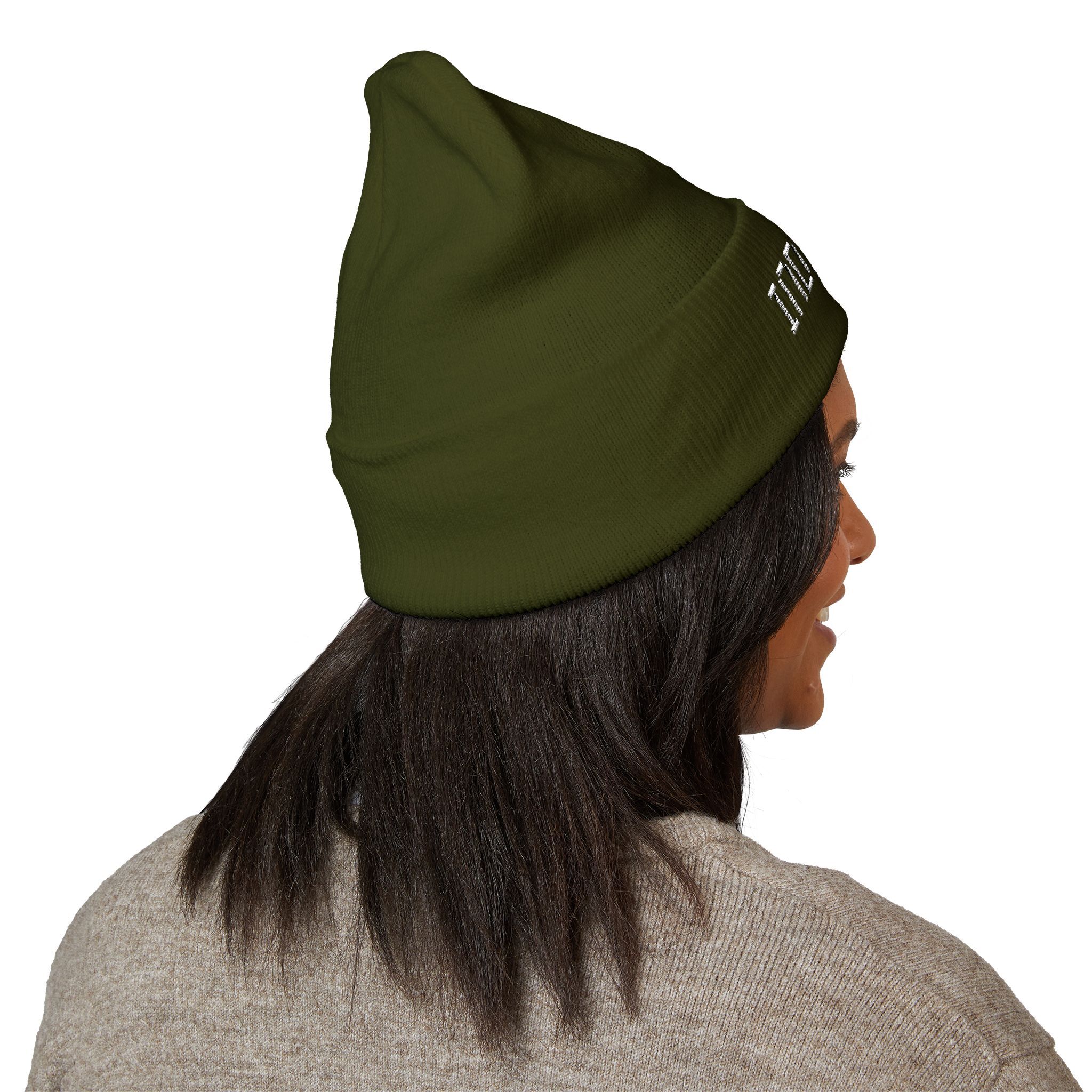 A person with straight dark hair wears The Deep Dive: Indie AF 2025 Holidays by Grown cuffed beanie in olive green with light embroidery and a beige sweater, photographed from behind at an angle.