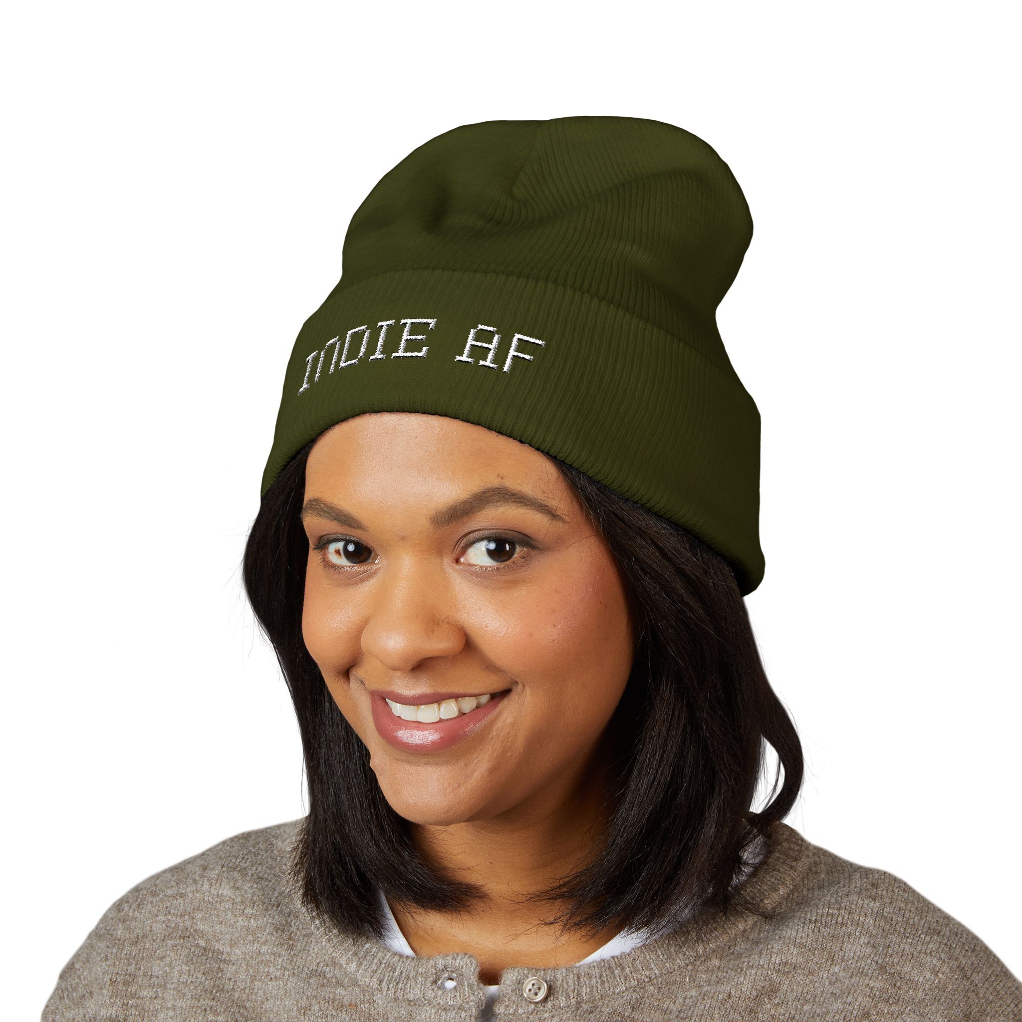 A woman smiles in a gray sweater and The Deep Dive: Indie AF 2025 Holidays by Grown cuffed beanie, featuring light embroidery, set against a plain white background.