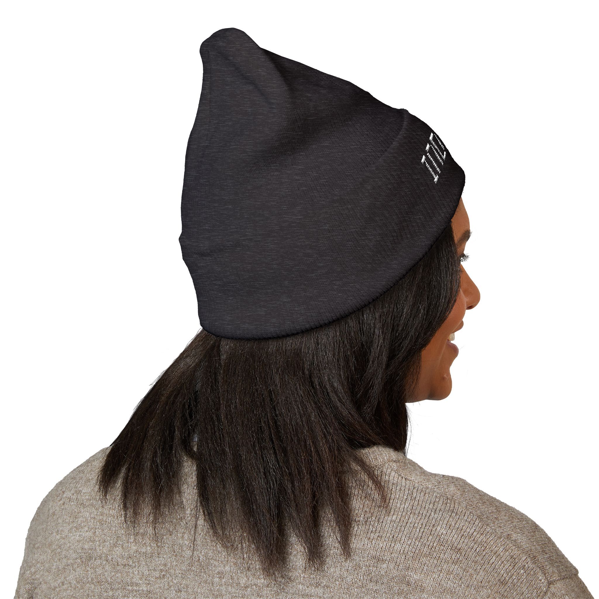 Someone with straight dark hair models The Deep Dive: Indie AF 2025 Holidays by Grown cuffed beanie in black with light embroidery, paired with a beige sweater, viewed from behind against a white background.