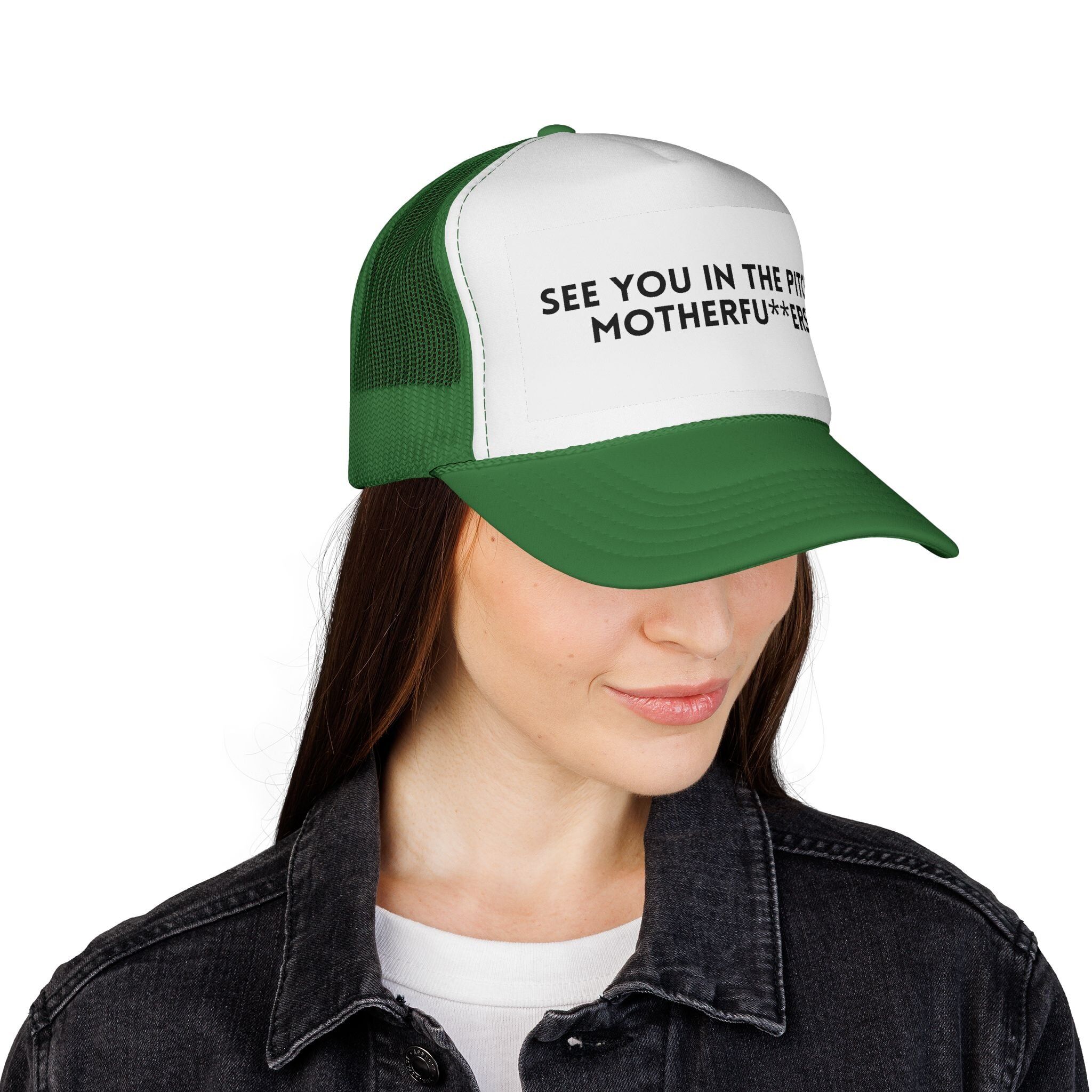 A woman wears The "See You in the Pitch, Motherfu**ers!" Trucker Hat in green and white, the bold statement partially hidden by the brim—perfect for making a scene-stealing entrance.
