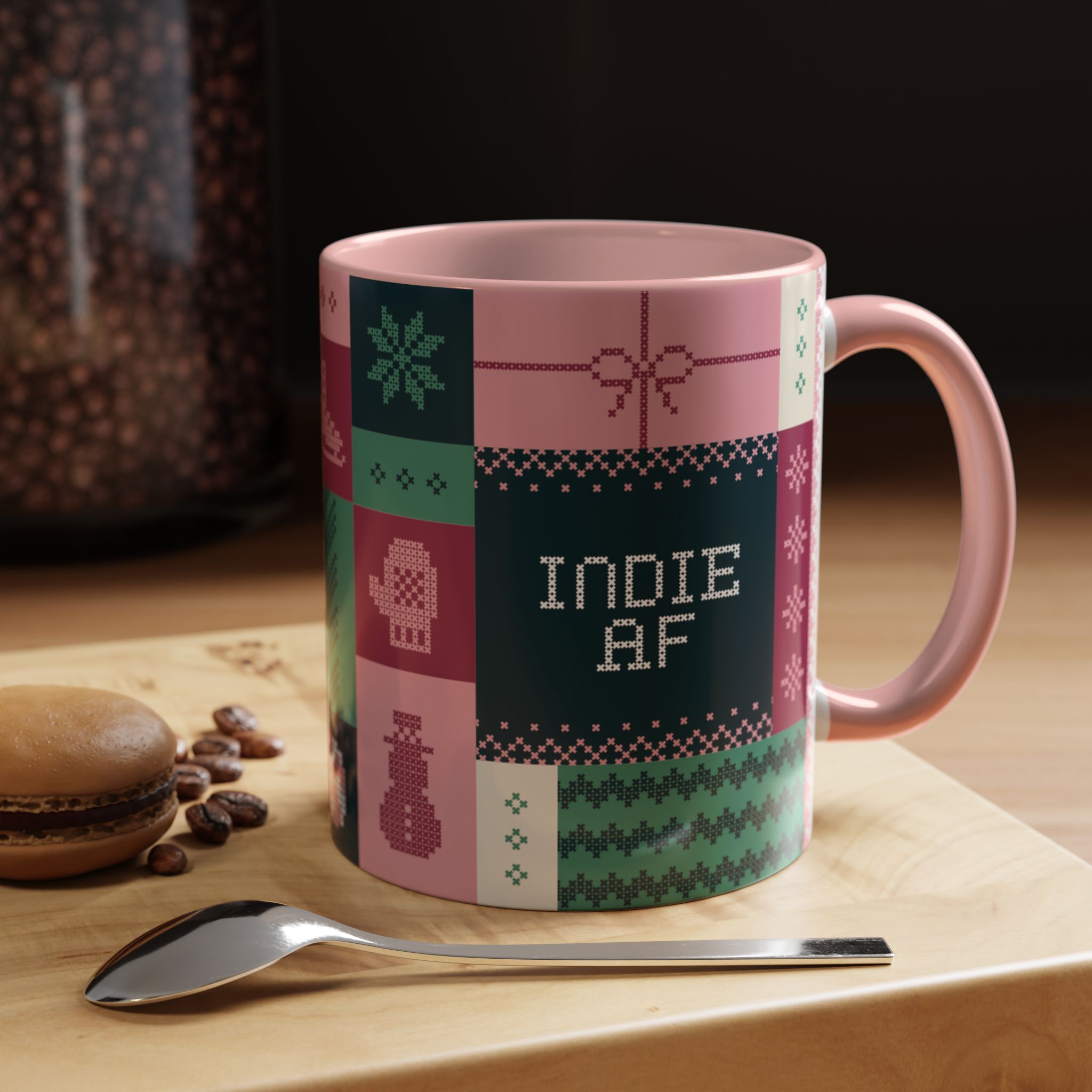 The "Mandatory Fun" Mug - Pink | 11oz Indie AF 2025 Holidays by Grown features a stitched-style pattern, displayed on a wooden tray with a spoon, macaron, and coffee beans—ideal for celebrating the 2025 Holidays in style.
