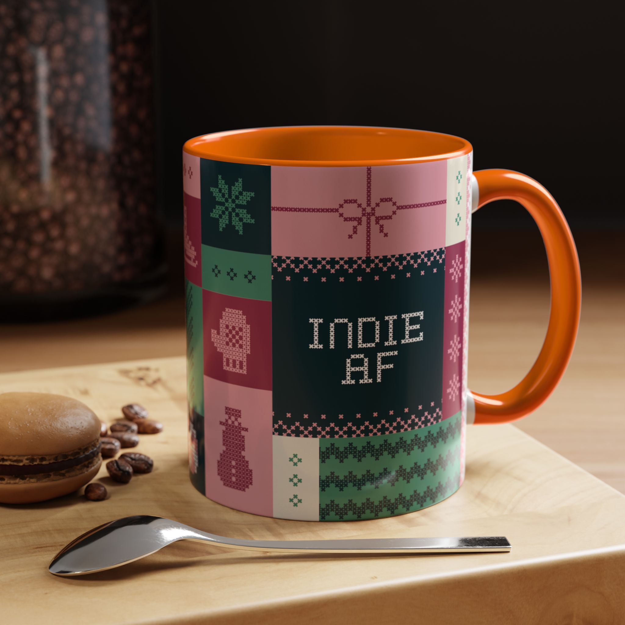 The "Mandatory Fun" Mug - Pink | 11oz features pixel-style INDIE AF graphics and an orange handle, sitting by coffee beans, a spoon, and a macaron—an ideal addition to your Grown Indie AF 2025 Holidays mug collection.