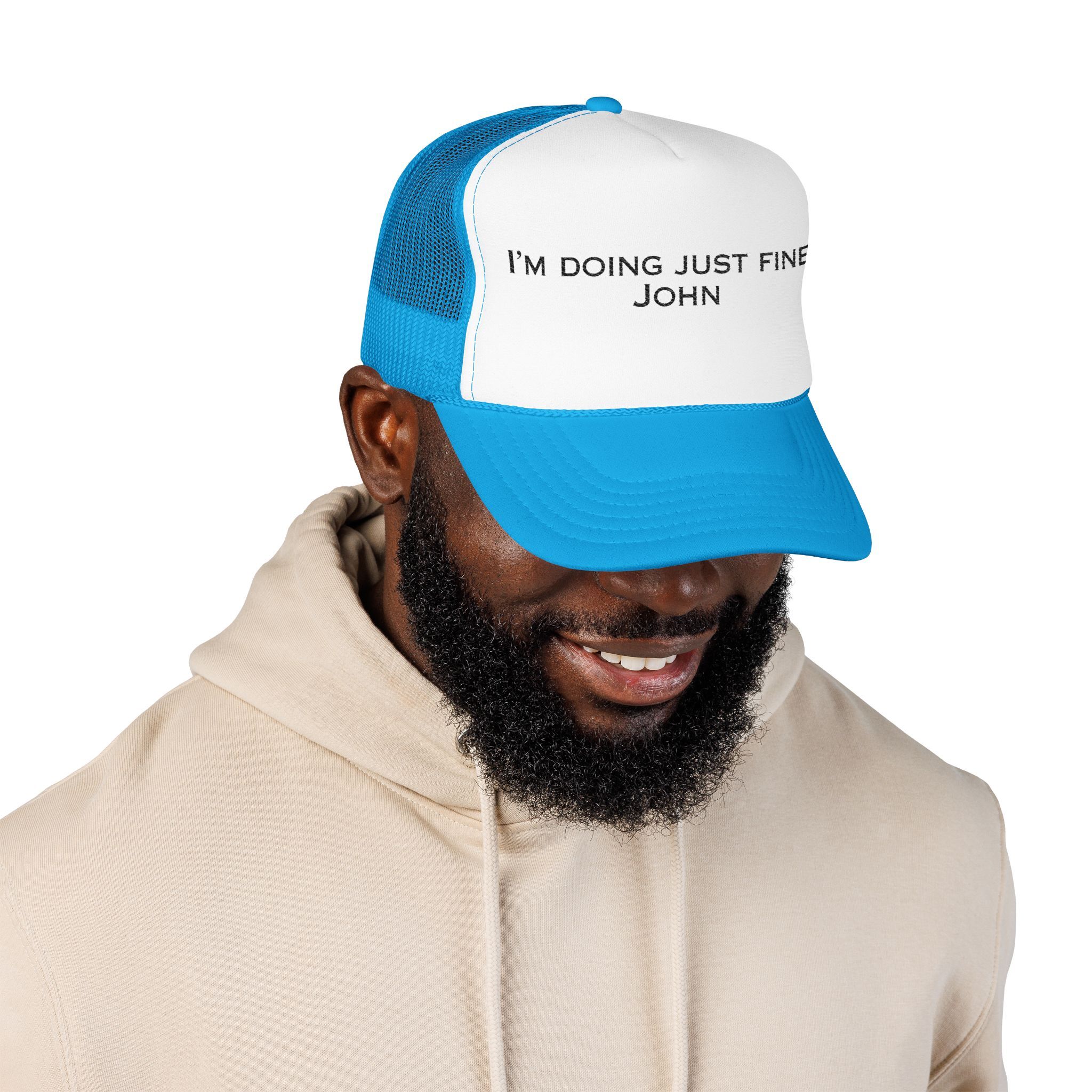 A man in a light hoodie wears The "I'm Doing Just Fine, John" Trucker Hat in blue and white.