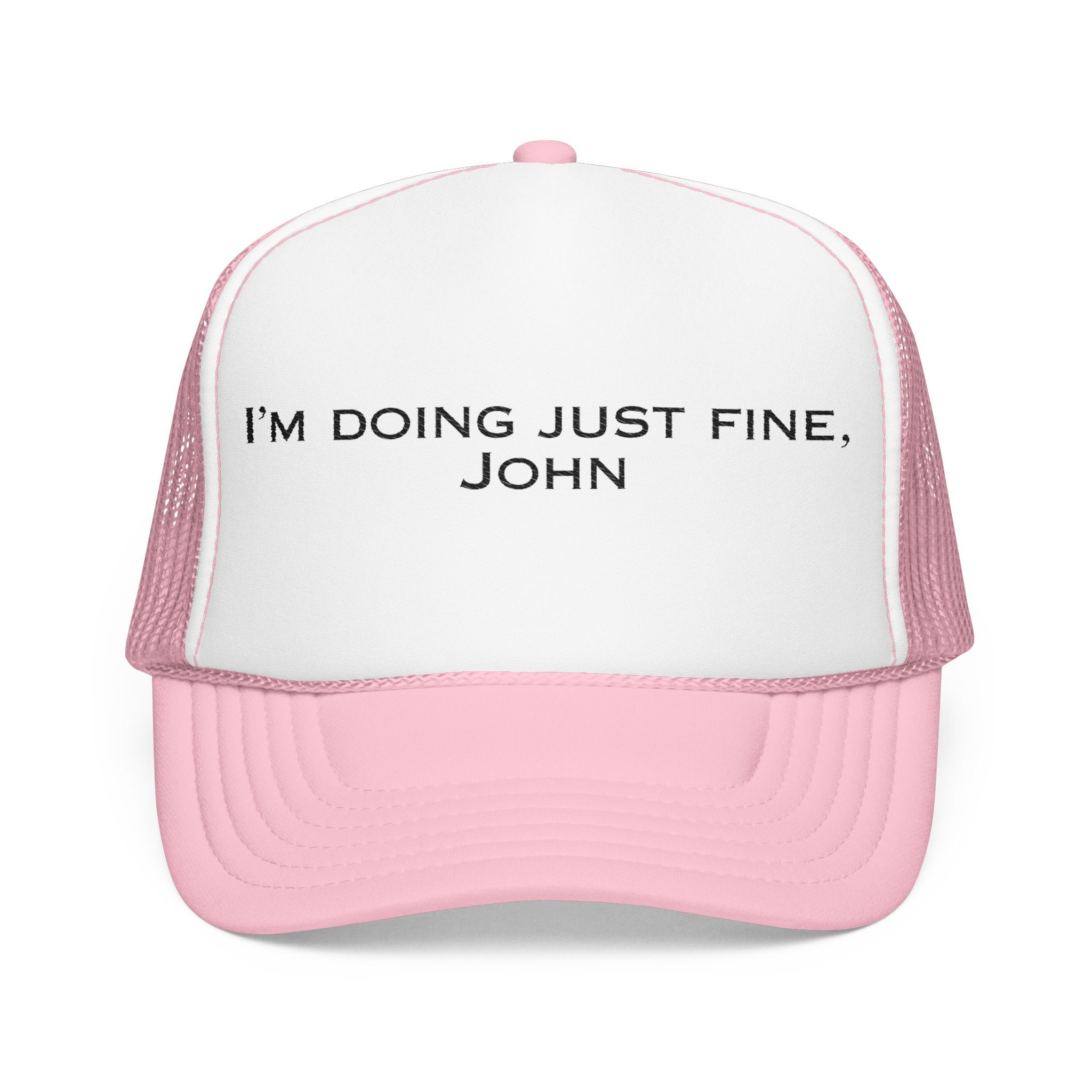 The "I'm Doing Just Fine, John" Trucker Hat comes in light colors like white and pink, with the phrase boldly printed in black on the front.