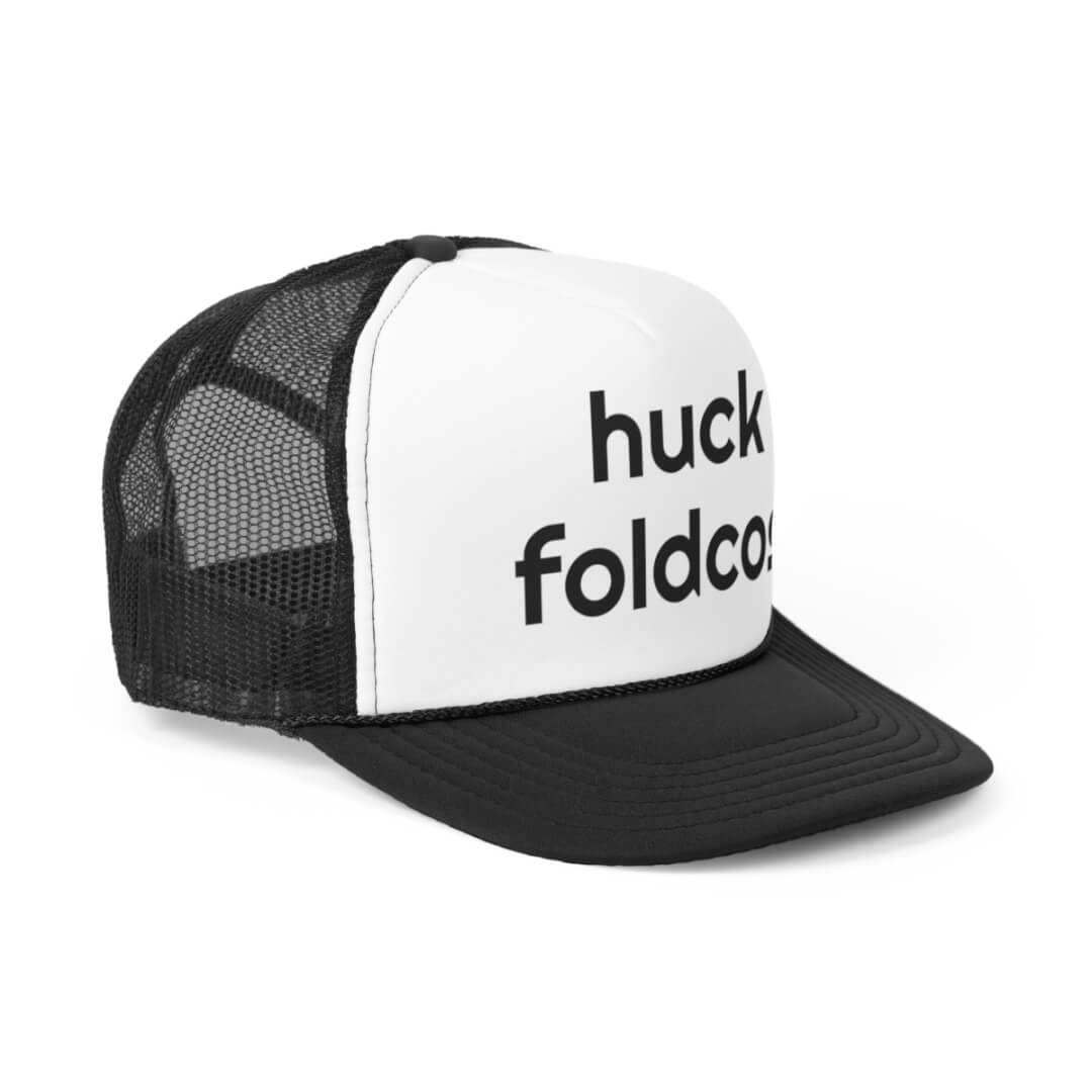The Foldcos Trucker Hat features a black and white design with huck foldco. boldly printed in black on the front panel.