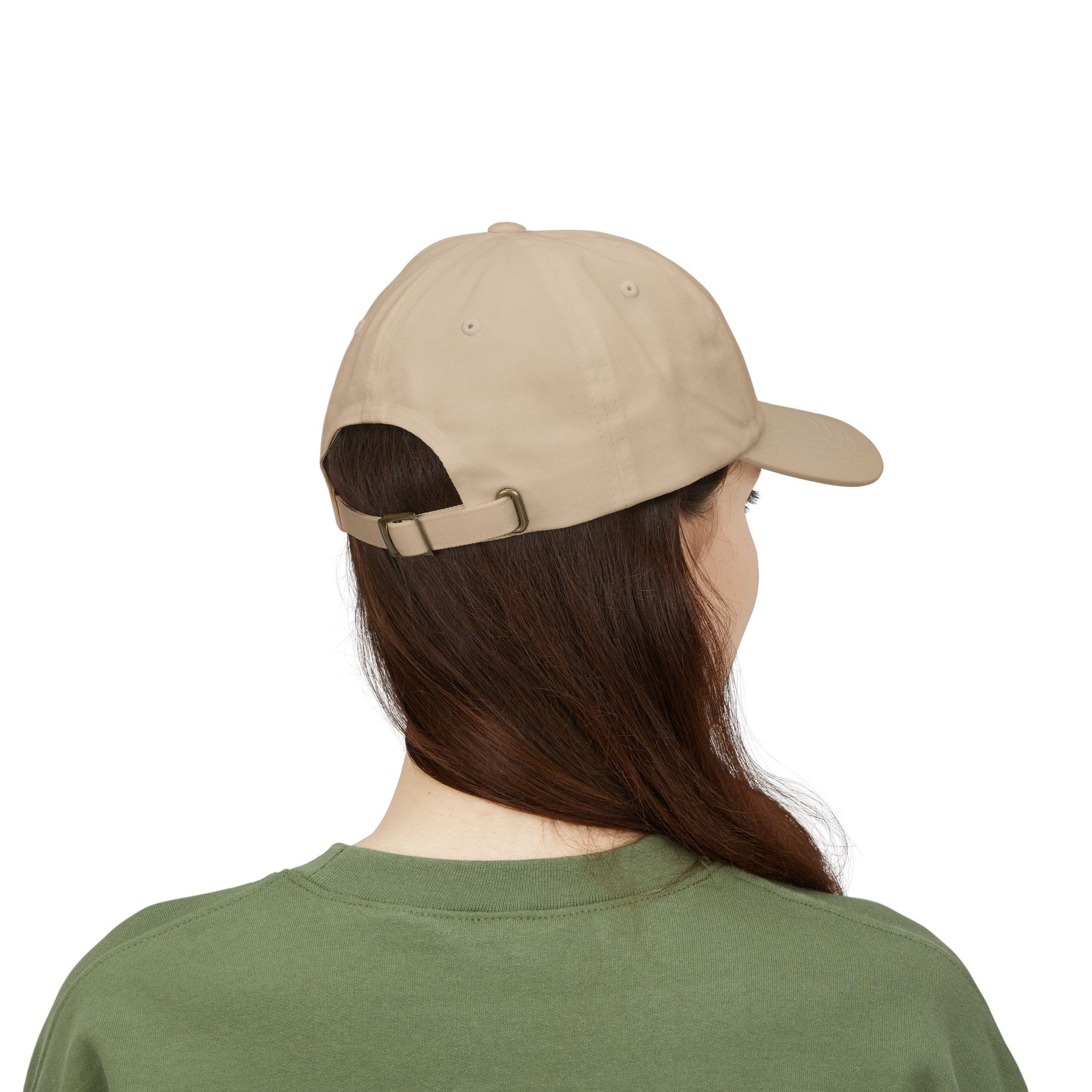 A person with long brown hair wears the Macrons Secret Weakness Baseball Cap and a green shirt, seen from behind against a white background, their look giving no clue to any hidden vulnerability.