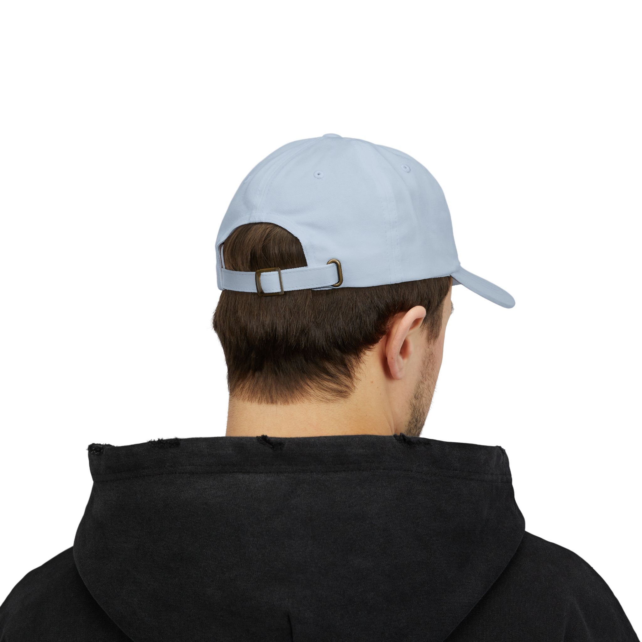 A person wearing The Macrons Secret Weakness Baseball Cap in light blue, backwards, with a black hoodie, shown from behind against a plain white background.